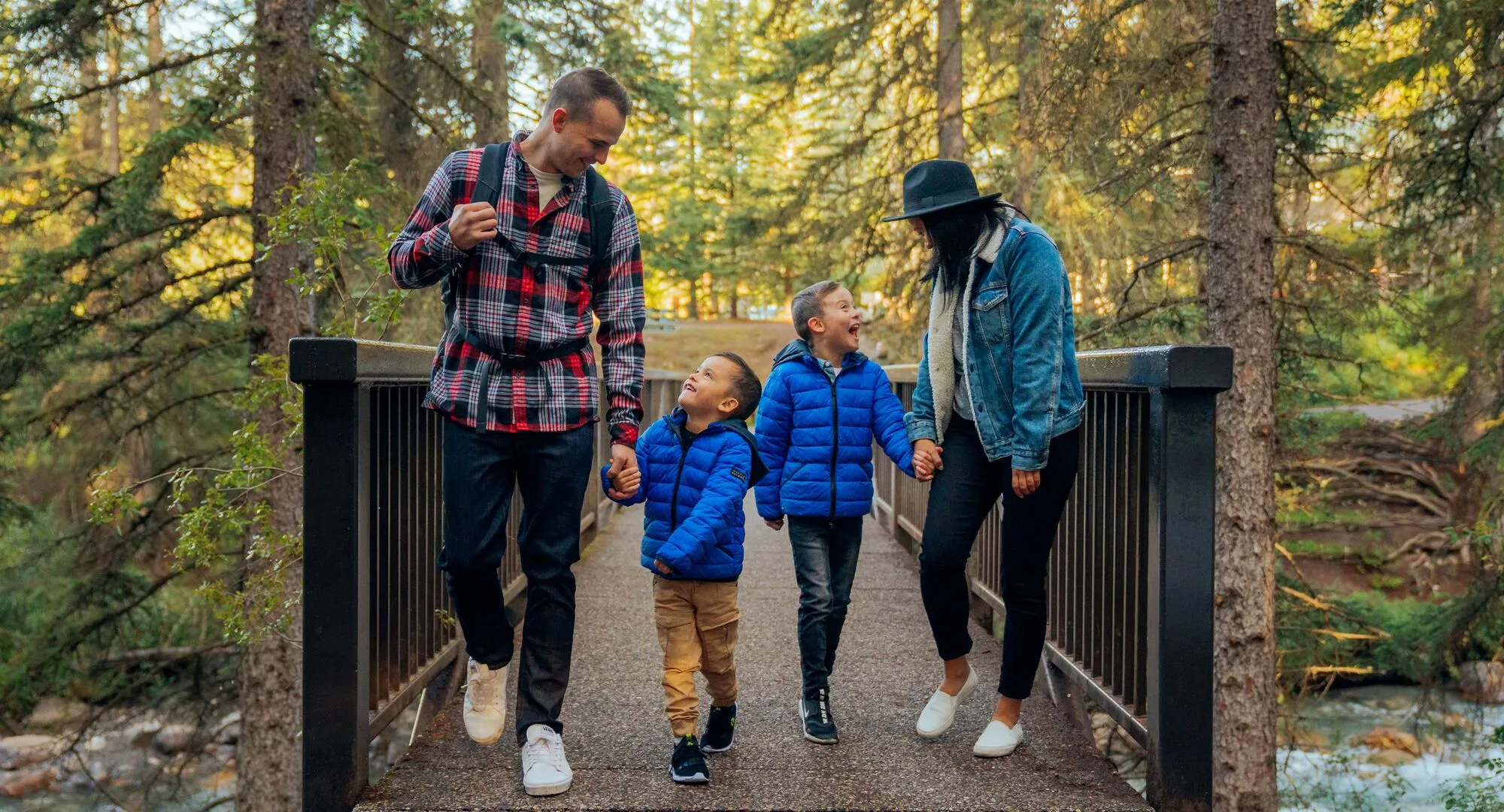 Family hiking in Johnston Canyon, Banff National Park with stunning mountain views
